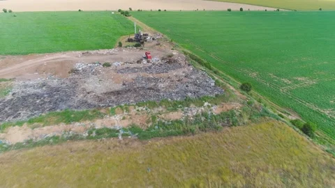 Large garbage dump among a green field Stock Footage 273206699