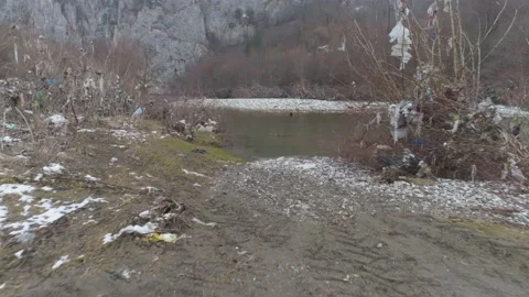 Large garbage landfill, trash dump close to clean mountain river Stock Footage 170699881
