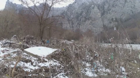 Large garbage landfill, trash dump close to clean mountain river Stock Footage 170700122