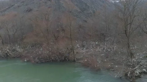 Large garbage landfill, trash dump close to clean mountain river Stock Footage 170700187