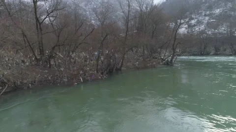 Large garbage landfill, trash dump close to clean mountain river Stock Footage 170700571