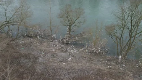 Large garbage landfill, trash dump close to clean mountain river Stock Footage 170701094