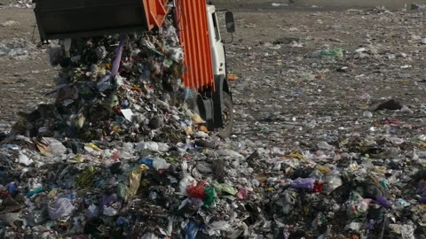 A large garbage truck dumps garbage at a dump. Stock Footage 315295693