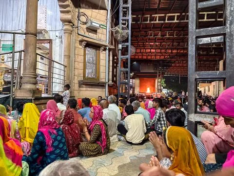 Large gathering of devotees inside indian temple complex during religious vis 写真素材