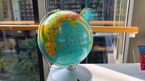 A large geographical globe on a table in an office room. Stock Footage 288450756