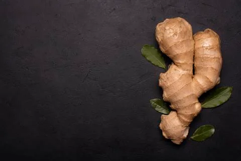Large ginger root on black background Stock Photos