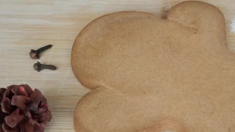 Large gingerbread cookie on wooden board with spices and baking ingredients Stock Footage 341499738