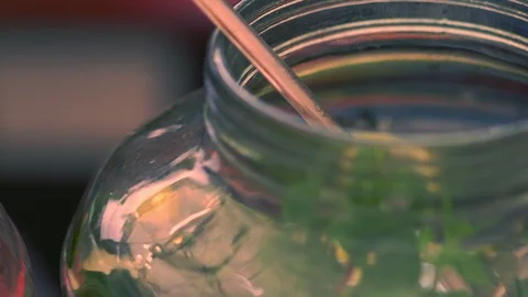 Large glass kitchen jars with assorted garnishes Stock Footage 115076388