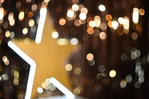 Large glowing star turned to the side background blurred against the background Stock Photos