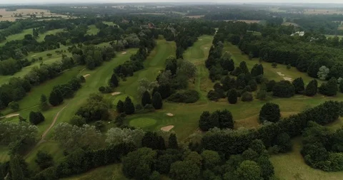 Large Golf Course with trees and green fairways. Overcast day drone aerial 4k Stock Footage 124647320