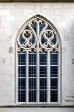 Large gothic window with ornate stone tracery Stock Photos