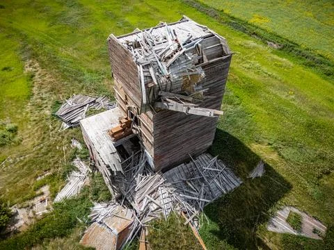 Large grain elevator with a lot of debris on the ground Stock Photos