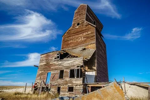 A large grain elevator sits in a field Stock Photos