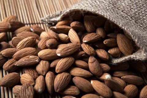 Large grains of almonds in the shell and the bag Stock Photos