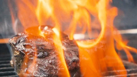Large grains of pepper fall on tasty beefsteak, delicious juicy meat Stock Footage 107741094