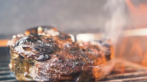 Large grains of pepper fall on tasty beefsteak Stock Footage 107741120