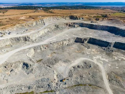 A large granite quarry is in operation, with visible paths and equipment. The Фото