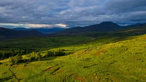 A large, grassy field with a cloudy sky in the background Stock Footage 327907969