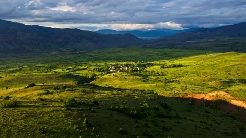 A large, grassy field with a mountain in the background Stock Footage 327907933