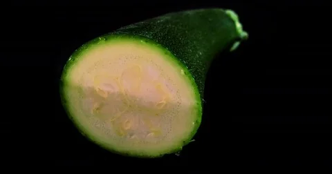 Large green courgette being chopped up like magic in stop motion animation. Video stock 75735749