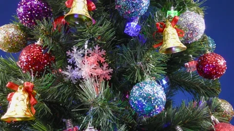 A large green decorated Christmas tree on a blue background with a zoom Stock Footage 166840598
