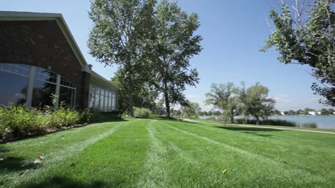A large green field in front of a house Stock Footage 156010633