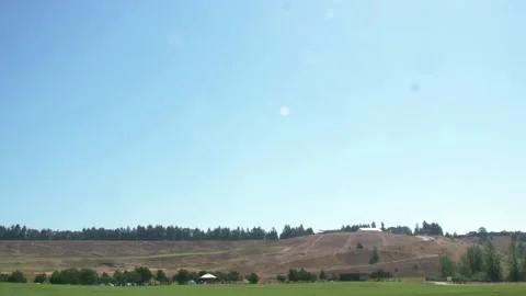 A large green field with trees in the background Stock Footage 156012828