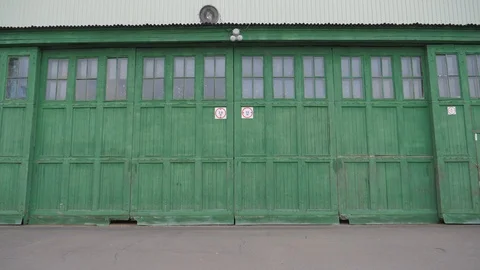 Large green gate from the hangar Stock Footage 108395752