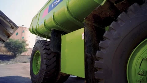 Large green mining dump truck wheel moving at a quarry or factory 스톡 동영상 332103630