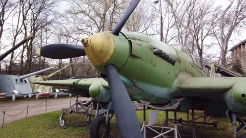 Large green propeller airplane displayed outdoors at aviation museum 動画素材 342020686