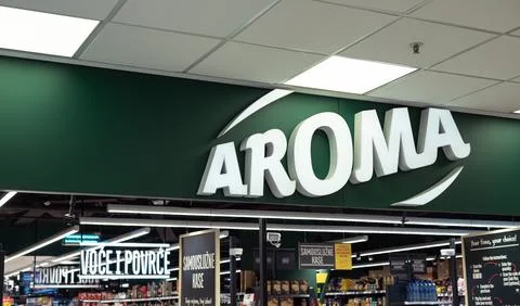 Large green storefront sign for the Aroma supermarket chain inside a store 库存照片