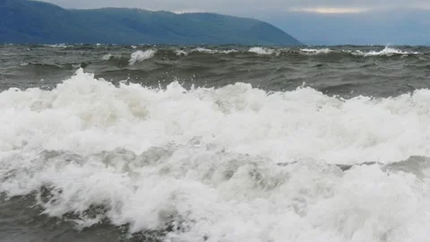 Large grey waves roll towards the coast on a stormy day. Stock Footage 290118802