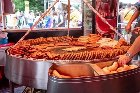 Large grill filled with various types of german sausages Stock Photos