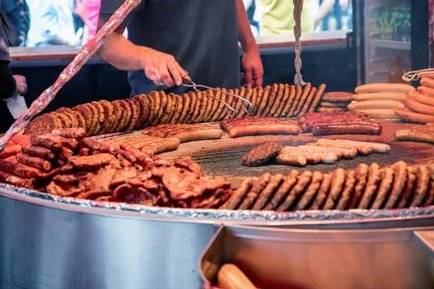Large grill filled with various types of german sausages Stock Photos