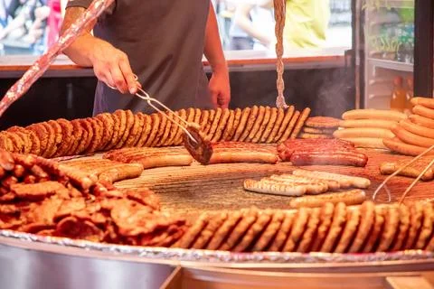 Large grill filled with various types of german sausages Stock Photos