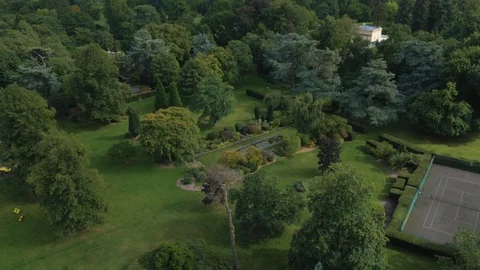 Large grounds of stately home with well kept trees and flowers , drone aerial 4K Stock Footage 101127620
