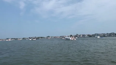 Large group of boaters parties near the marina at Surf City New Jersey Stock Footage 137202553