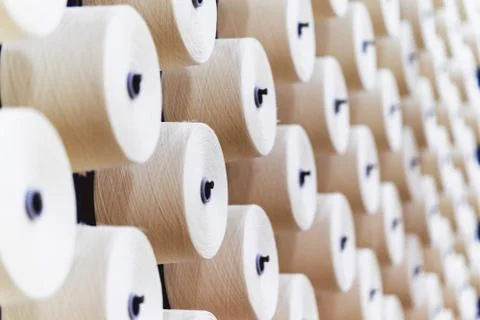 Large group of bobbin thread cones on a warping machine in a textile mill. Stock Photos
