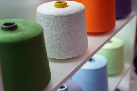 Large group of bobbin thread cones on the shelf Stock Photos