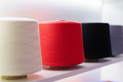 Large group of bobbin thread cones on the shelf Foto stock