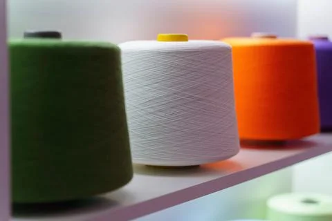 Large group of bobbin thread cones on the shelf Stock Photos