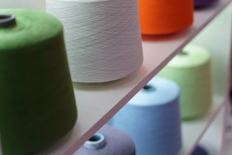 Large group of bobbin thread cones on the shelf Stock Photos