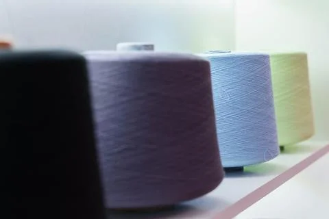 Large group of bobbin thread cones on the shelf Stock Photos