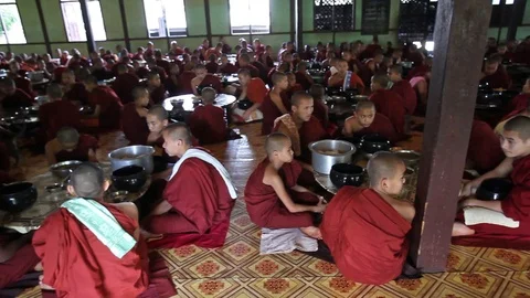 Large group of Buddhist monks chanting before meal, Myanmar Video stock 123686313