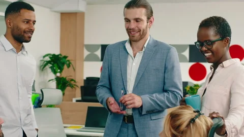 A large group of co-workers and managers are having a friendly meeting in a Stock Footage 166906102
