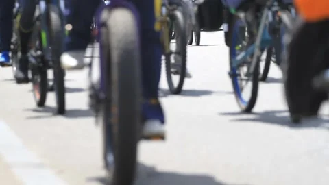 A large group of cyclists drive along the road Stock-Footage 94937799