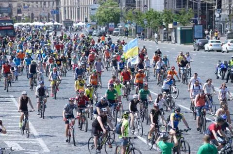 Large group of cyclists moving down the street road Stock Photos