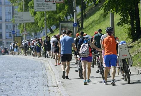 Large group of cyclists moving down the street road. Cycle race among amate.. Stock Photos