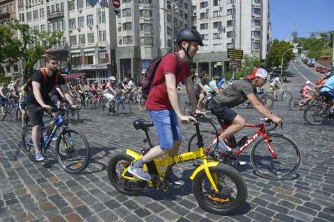Large group of cyclists riding down the street road, bicycles. Cycle race amo Stock Photos