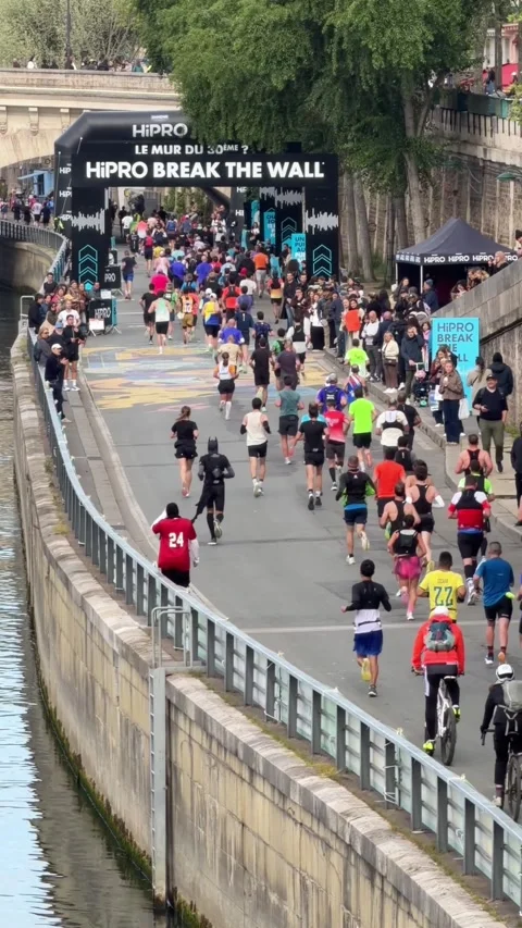 Large group of diverse people participating in the HiPRO Break The Wall running Stock Footage 337783446
